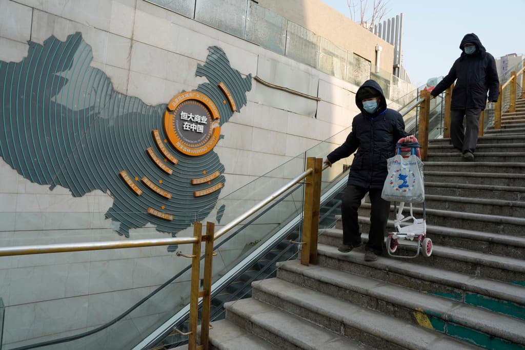 AP/Ng Han Guan Residents walk through a partially shuttered Evergrande commercial complex at Beijing on January 29, 2024.